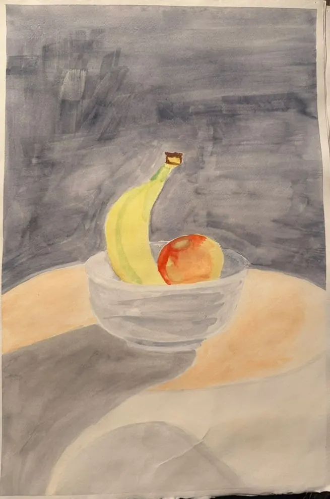 Banana and Apple: a banana and a red apple sit in a glass bowl on a round, sunlit table