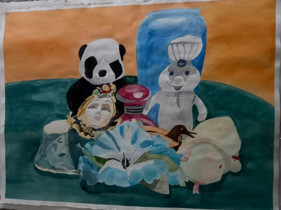 Panda and Friends: a toy panda, a white chef figure, a doll's head, and a ruffled blue flower crowd together on a green table