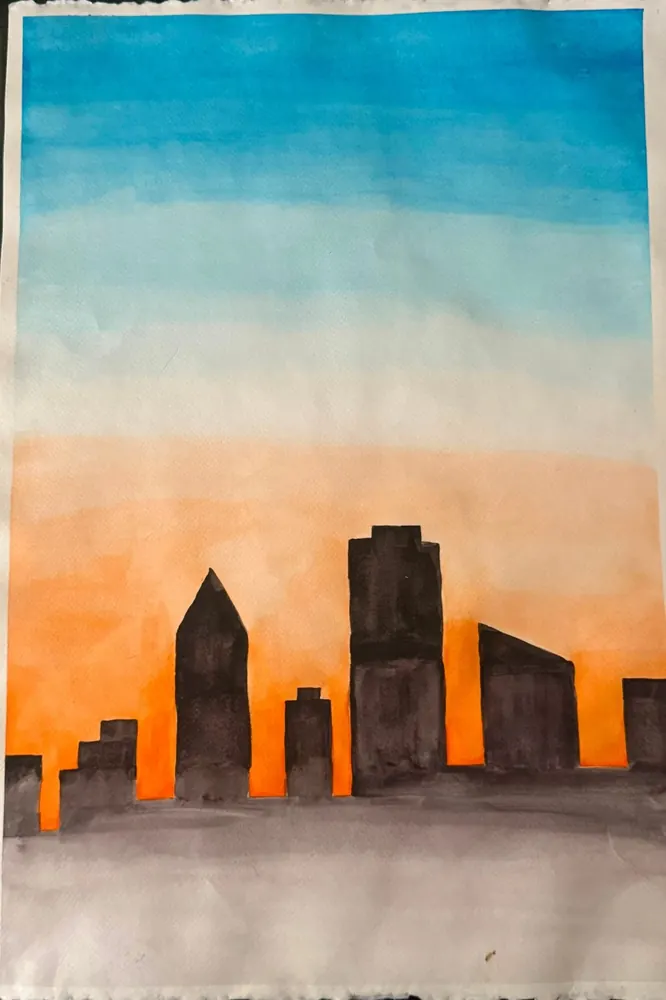 Skyline at Dusk: a silhouetted city skyline against a sky fading from blue to orange